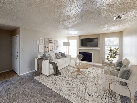 a living room with a white couch and a fireplace